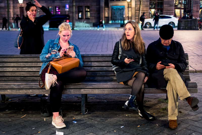 Group of people engrossed in screens by Jukka Heinovirta